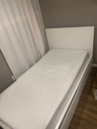 White bed frame and mattress