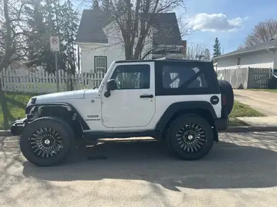 Jeep Wrangler Sport in great condition, manual transmission, soft top, 145,000km. 3 sets of rims and...