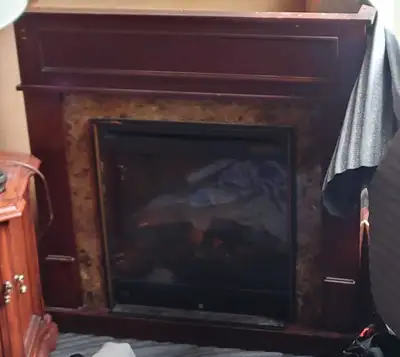 Dimplex Electric Fireplace with solid hardwood mantle. Thermostat controlled with low and high fan s...