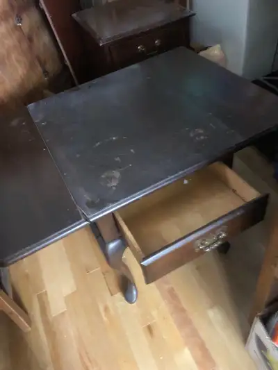 Wood coffee table with wings that fold down. , View more