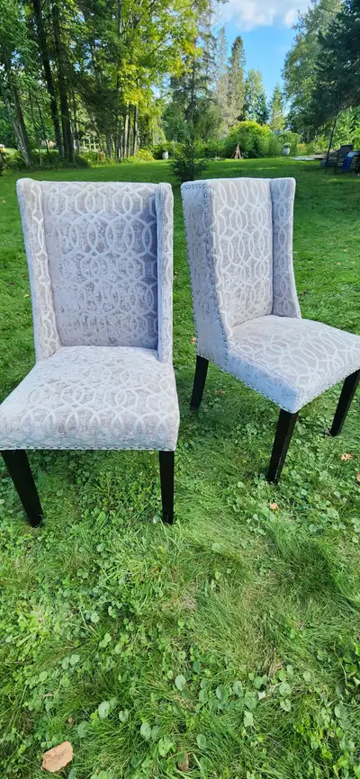 Two silver and white high-back fabric rivetted chairs. Paid 175ea. but happy to let both go for $200...