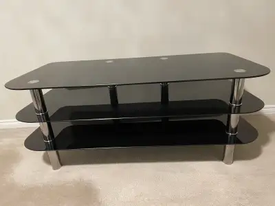 Sleek black glass TV stand with chrome legs