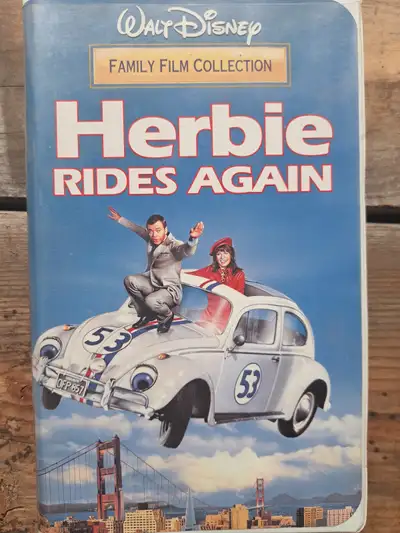 Classic Disney movie "Herbie Rides Again" on VHS tape. In clamshell which has minor wear.