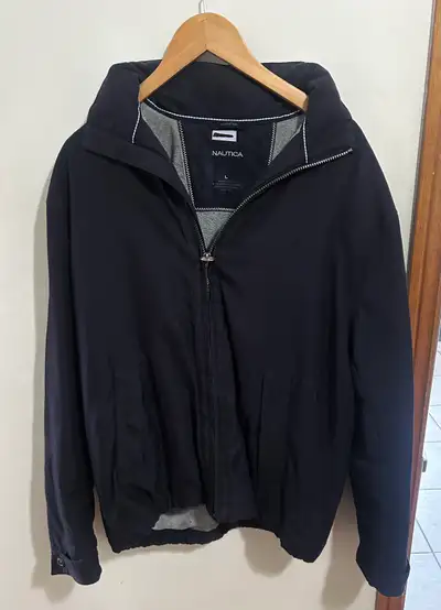 This is a used Nautica jacket in a size large, perfect for cool weather. The jacket is in excellent...