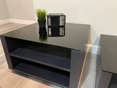 Solid coffee table and end table from EQ3. Black base and tinted dark grey glass tops. Storage spots...