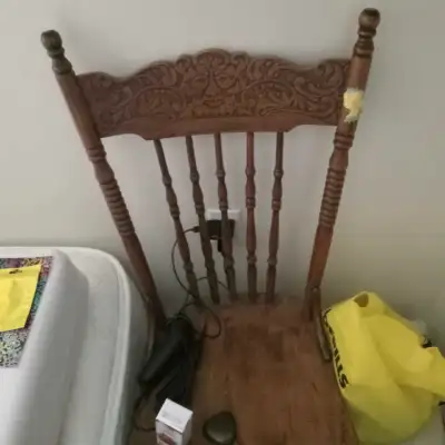 This is a used wooden chair with an ornately carved backrest, perfect for adding a touch of vintage...