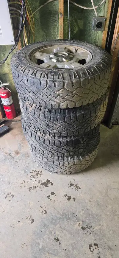 6 bolt 6x135 rims with center caps 245 75 17 s duratraks Loacted in peebles 1-306-570-7039 Ford f150...