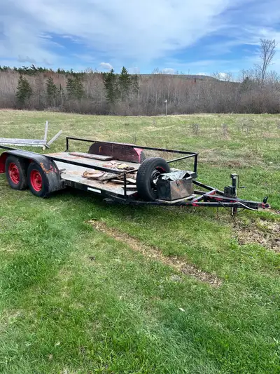 This tandem axle utility trailer features a robust steel frame and a durable steel deck, providing a...