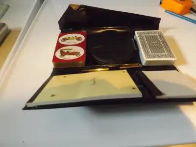 Lovely bridge set in a leather case. Contains 2 decks of cards, 1 score pad, drink coasters, 1 pen....