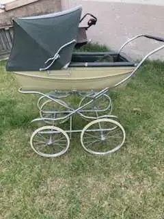 This is a vintage stroller with a unique design, perfect for collectors or those looking for a class...