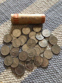 Roll of 1968 Canadian quarters. 