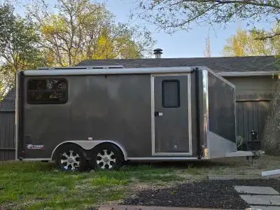 7x14 aluminum v nose cargo trailer toy hauler. Interior cabinets and fridge. 2x large Solar panels o...