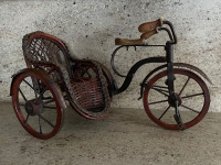 Vintage wood and metal toy tricycle with a wicker basket sidecar