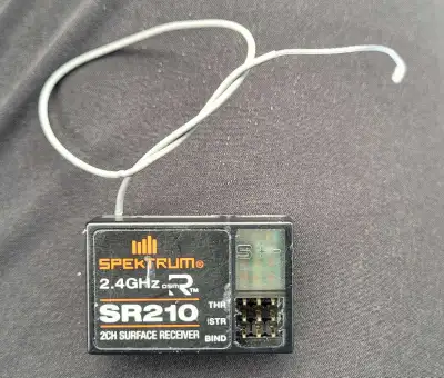Spektrum SR210 DSMR 2.4GHz 2-channel surface receiver. Compact and reliable — ideal for RC cars and...