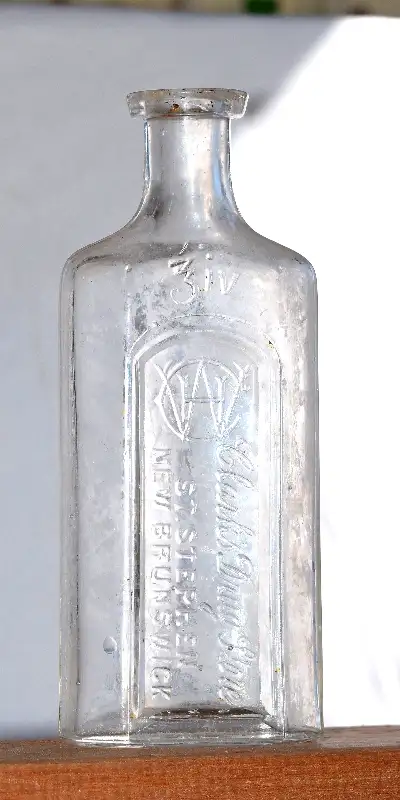 An antique St. Stephen drugstore bottle. Four oz 5 1/2" tall in clear glass. With nice monogram. No...