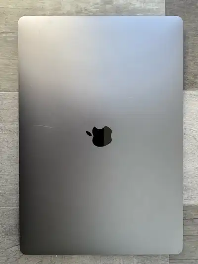 This is a used Apple MacBook Pro 15-inch from 2019, featuring a 2.6 GHz 6-Core Intel Core i7 process...