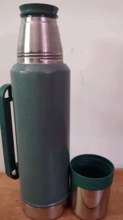 Stainless Steel Stanley Thermos Comes with detachable cup Over a foot high so holds a ton Keeps ever...