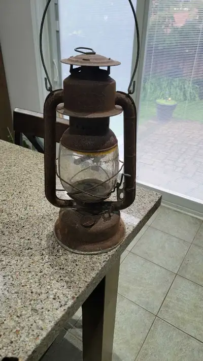 an old rusted lantern with original parts and globe. Nice to have for collection or use.