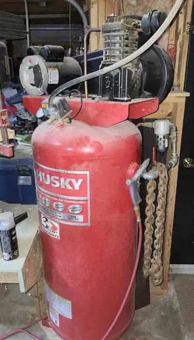 This is a used Husky 60-gallon air compressor, perfect for a home garage or small shop. It's a great...