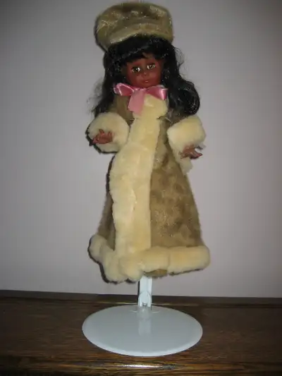 Lovely vintage doll with a seal skin coat, hat and boots Measures 20 1/2 " with stand Pick up in the...