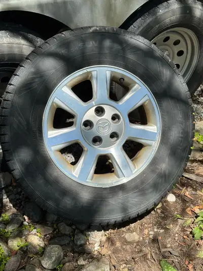 Selling a set of original alloy rims with winter tires, specifically designed for a Mazda Tribute. T...