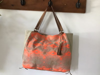 Popular Stella and Dot “IT” handbag in Aztec coral