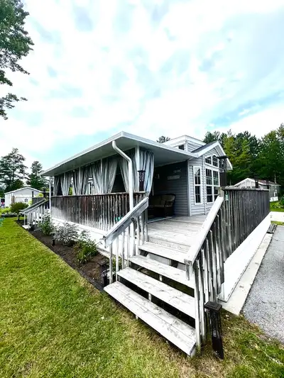 This beautifully upgraded corner lot seasonal 2014 Woodland Gramby Park Model offers the perfect ble...