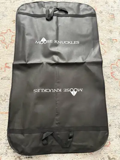 This is a Moose Knuckles garment bag, perfect for protecting your coat or other valuable clothing it...