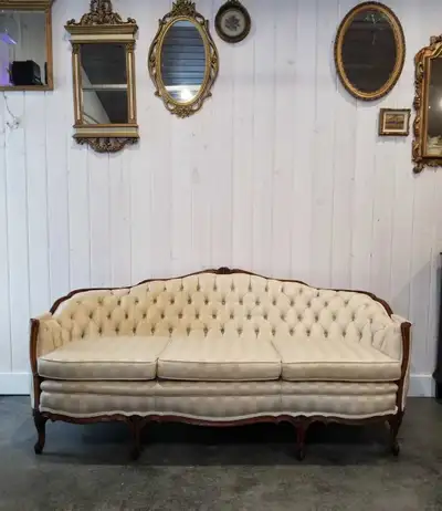 Antique French Provincial Sofa Cream colored upholstery Has been shampooed, but has some staining st...