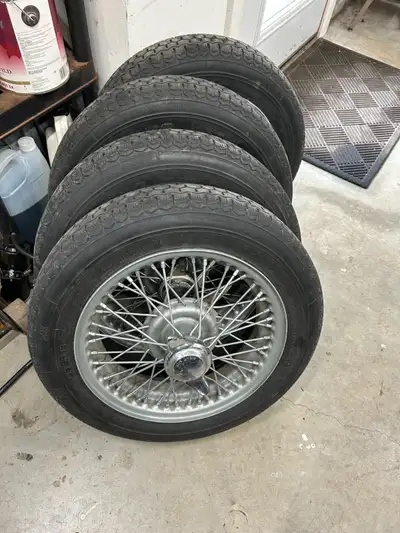 Set of four wire wheels 15 x 4, tires, hubs and spinners off of a Triumph TR3. Michelin ZX tires.