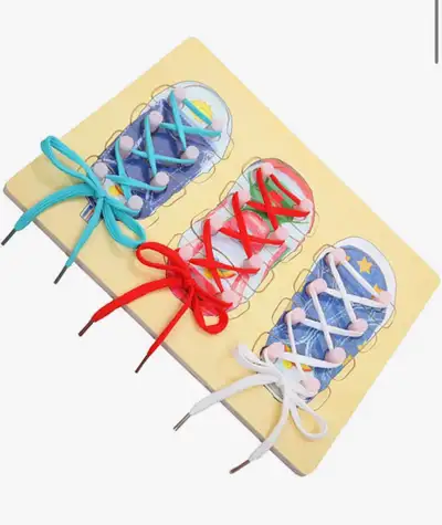 Master the art of tying shoelaces with this engaging wooden learning board featuring three colourful...