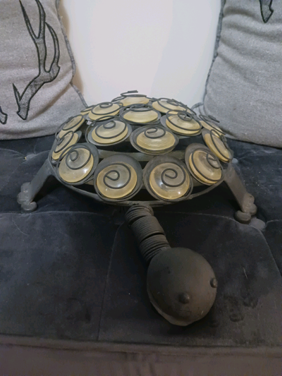 All Metal Turtle has metal spirals and glass disks for a shell. Unique piece.