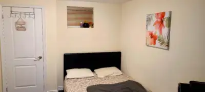 Private Bedroom: Comfortable bedroom with wall-mounted TV, mirrored closet, and neutral décor for a...