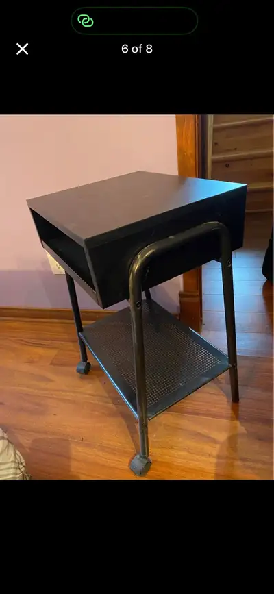 This sleek black IKEA nightstand is a stylish and functional addition to any bedroom, featuring a co...