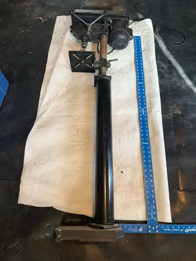 A drill press, View more
