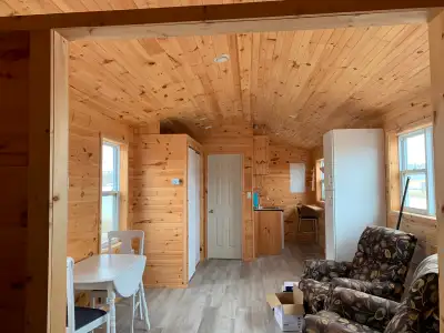 New 12 x 32 cedar shingled small house finished in pine. Wired (and for heat pump) 100 amp panel. an...