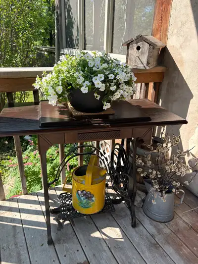 This beautiful antique sewing machine table has been lovingly refreshed to serve as a stunning rusti...