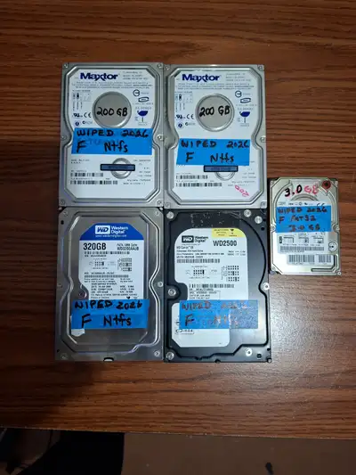 four 3.5" IDE Hard drives, various sizes. [2x 200 GB, 1x 320 GB, 1x 252 GB] one 2.5" IDE Hard Drive,...