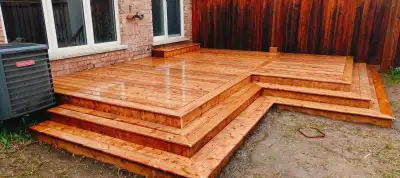 Elevate your outdoor living space with these custom-built wooden decks and fences, perfect for addin...