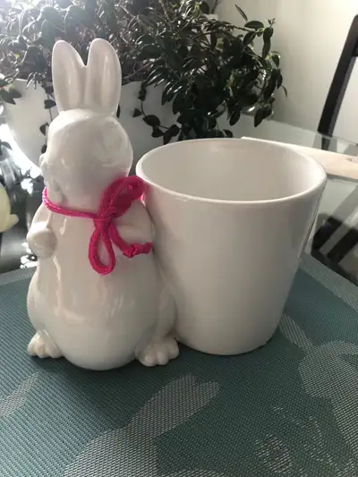 This adorable white ceramic bunny planter will add a touch of whimsy to any room or garden. It is in...