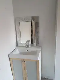 Clean Vanity with mirror and faucet