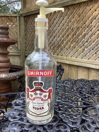 One gallon Ste. Pierre Smirnoff Vodka bottle with pump Empty Labels in good shape