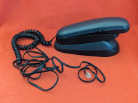 Black landline phone with cord and cradle