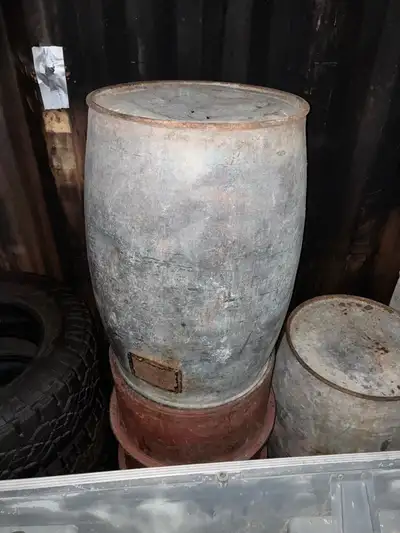Three antique oil drums. Two are imperial oi, riveted style with labels. The third is red with two r...