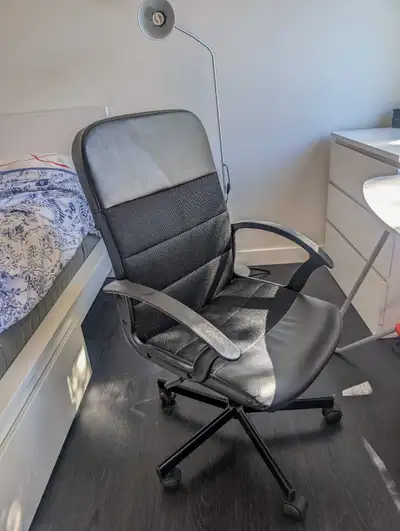This set includes a white desk with a red shelf and a black office chair, both in good condition and...