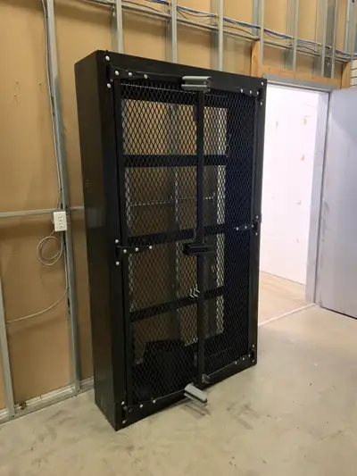 Heavy duty metal wall mounted locking gun/storage cabinet. 79.5” tall x 46” wide x 12” deep. Excelle...