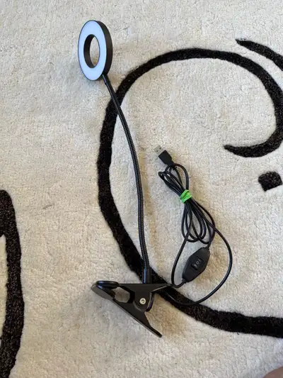 Illuminate your workspace with this adaptable clip-on LED ring light, perfect for desks, tables, or...
