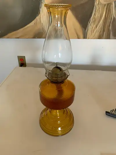 I'm offering a charming vintage amber glass oil lamp, perfect for adding a touch of nostalgia to you...