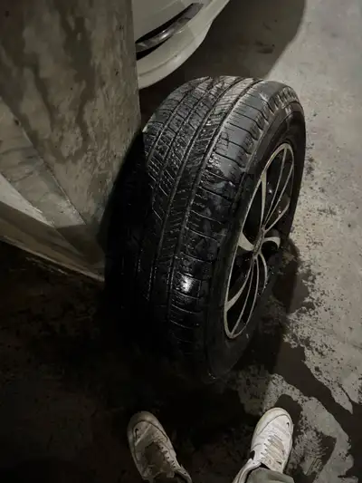 Set of four used all-season tires, size not specified but appear to be 17-18 inches, mounted on afte...