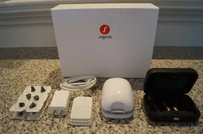 Gently used pair of Signia Charge-N-Go T-5X hearing aids with case, USB charger, sealed lithium-ion...